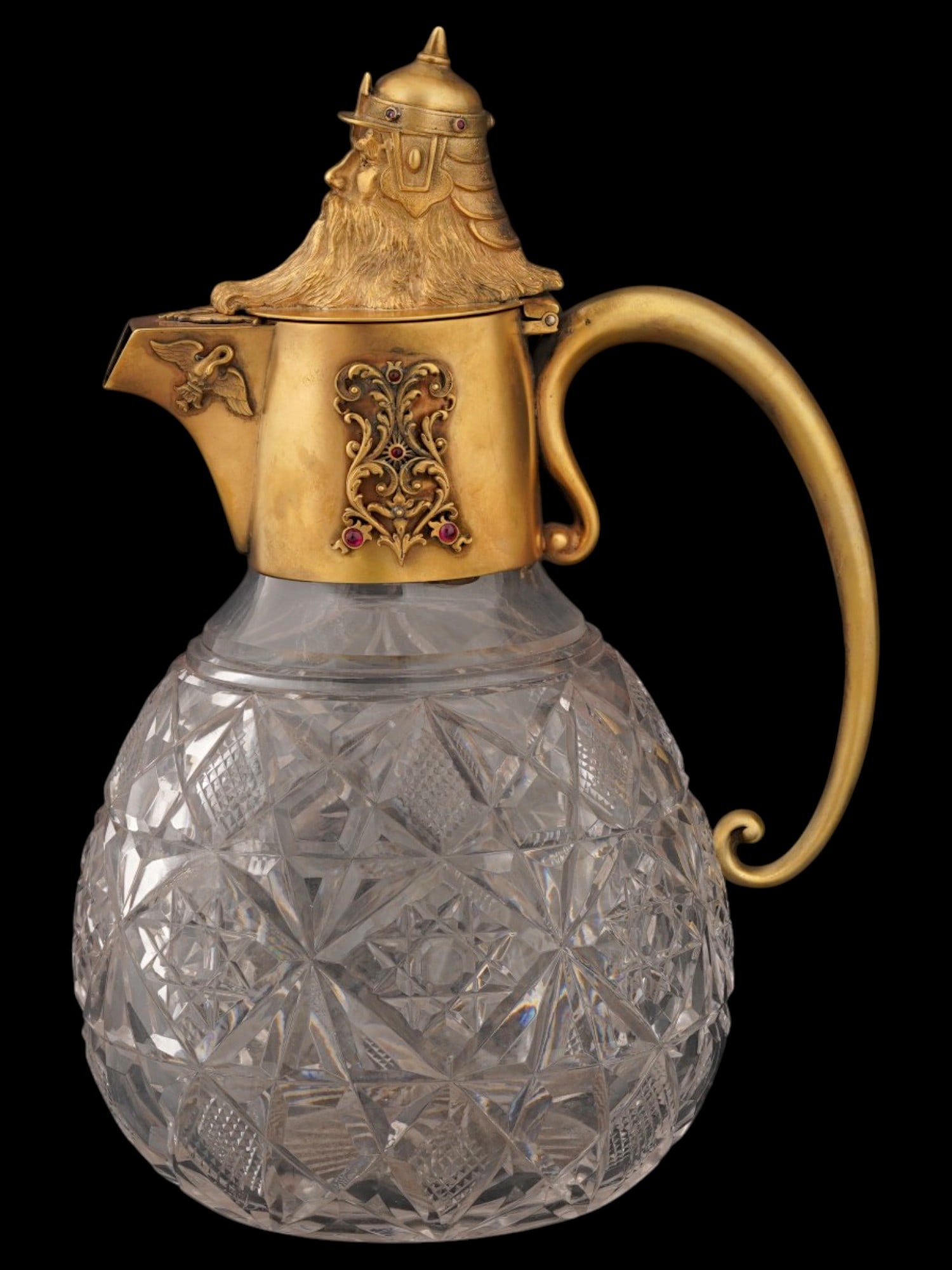 RUSSIAN GILT SILVER GEMS AND CUT GLASS PITCHER: A Russian gilt silver and crystal glass pitcher or wine jug embellished with gemstones. Round body with elaborate cut hobstar and crosshatching patter. The silver neck features relief ornaments and