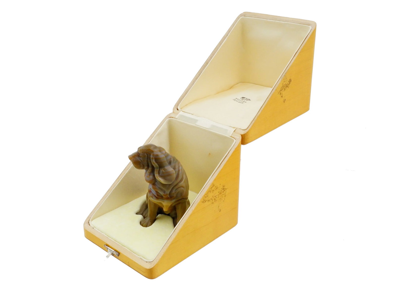 RUSSIAN CARVED AGATE DOG FIGURE WITH GEMSTONE EYES: A Russian hardstone carving depicting a Bloodhound or Basset Hound, sculpted from richly banded agate. The eyes of the dog are inset with cabochon gemstones mounted in gold wire settings. In the box.