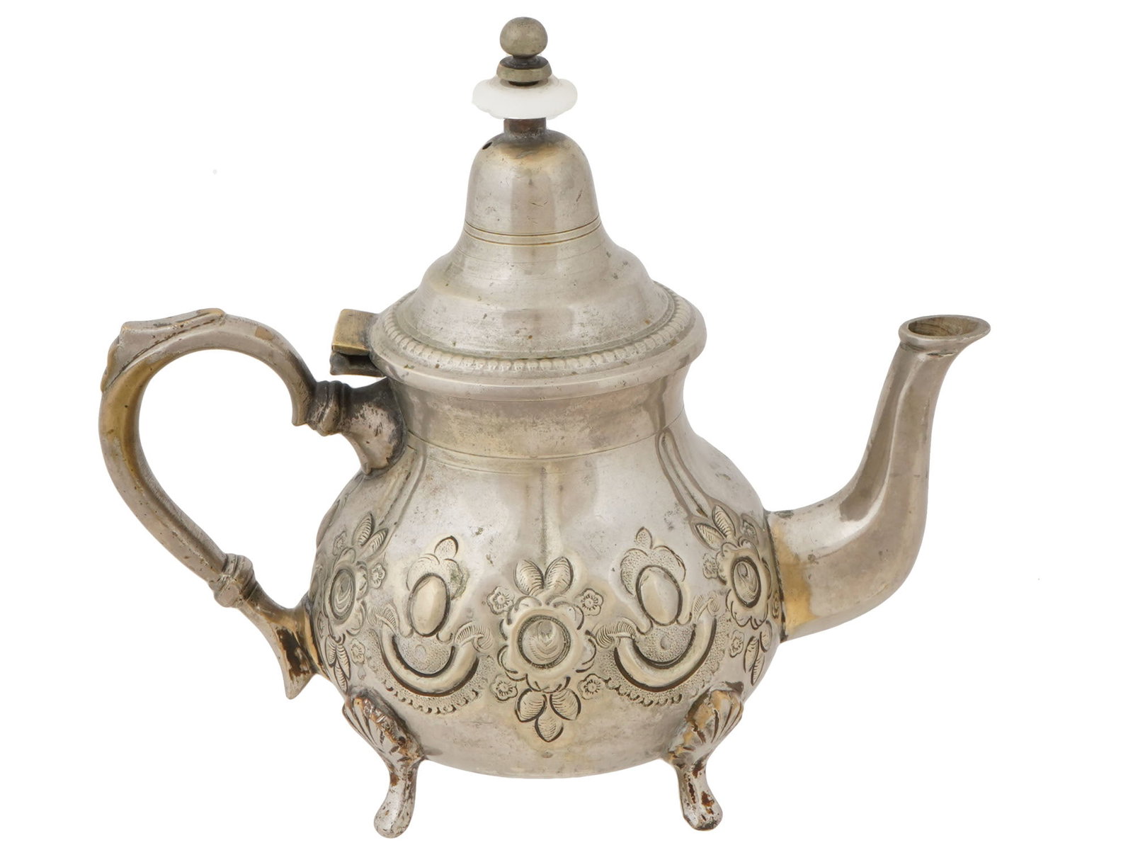 VINTAGE MOROCCAN SILVER PLATED HANDCRAFTED TEAPOT: A vintage Moroccan silver plated handcrafted teapot. Circa 1920s to 1950s. Raised on four legs, the teapot is pear-shaped, typical of the region, with a high lid, curved spout, and handle. The body is