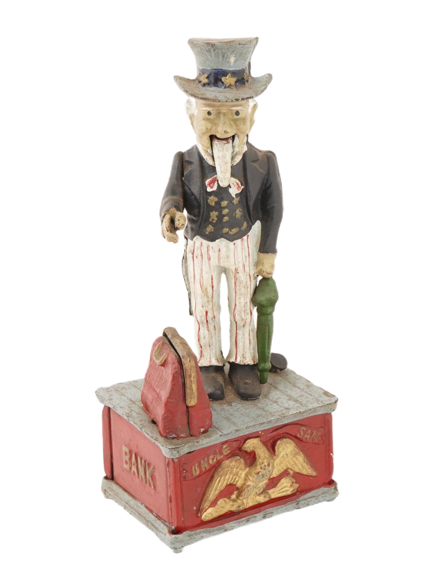 UNCLE SAM FIGURAL CAST IRON MECHANICAL COIN BANK: A vintage figural cast iron mechanical coin bank. The bank is adorned with a figure of Uncle Sam wearing a traditional top hat, a dark coat, and striking striped trousers. The base of the bank is