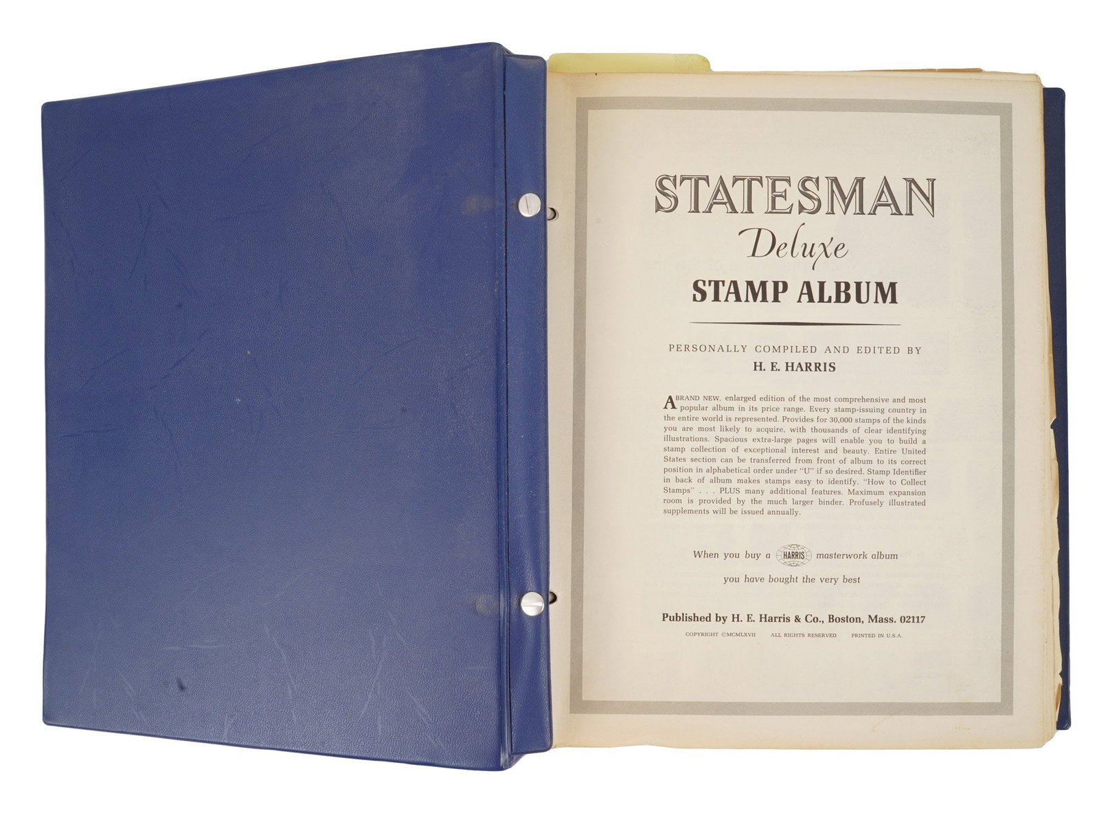 STATESMAN DELUXE STAMPS ALBUM BY HARRIS AND CO: A Statesman Deluxe Stamp Album, published by H.E. Harris and Co. of Boston, contains a diverse philatelic collection housed in a blue loose leaf binder. The volume features illustrated pages with desi