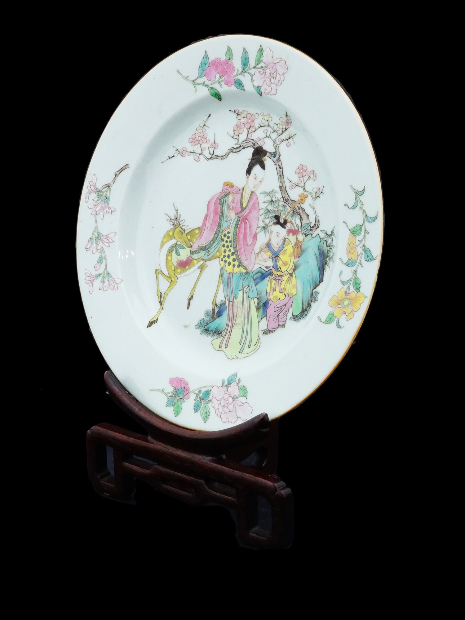 ANTIQUE QING CHINESE FAMILLE ROSE PORCELAIN PLATE: An antique Chinese, Qing Dynasty, 18th century Famille Rose porcelain ladies longevity wishing plate with a Magu fairy. The plate is adorned with a hand painted image of an Immortal fairy with a deer 