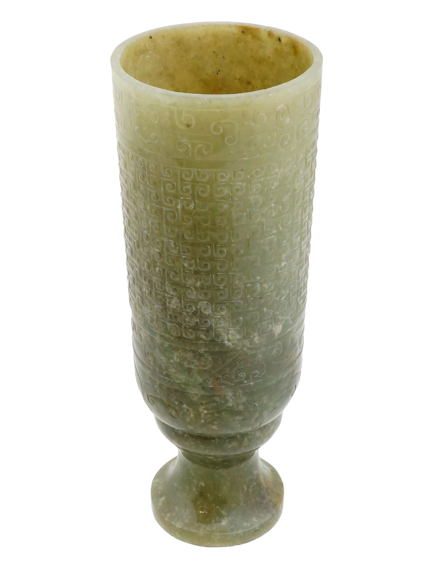 ANCIENT CHINESE HAND CARVED JADE GOBLET: An ancient Chinese hand carved jade goblet, featuring archaic low relief decoration. The cylindrical body is divided into horizontal registers adorned with stylized geometric scrollwork motifs and sup