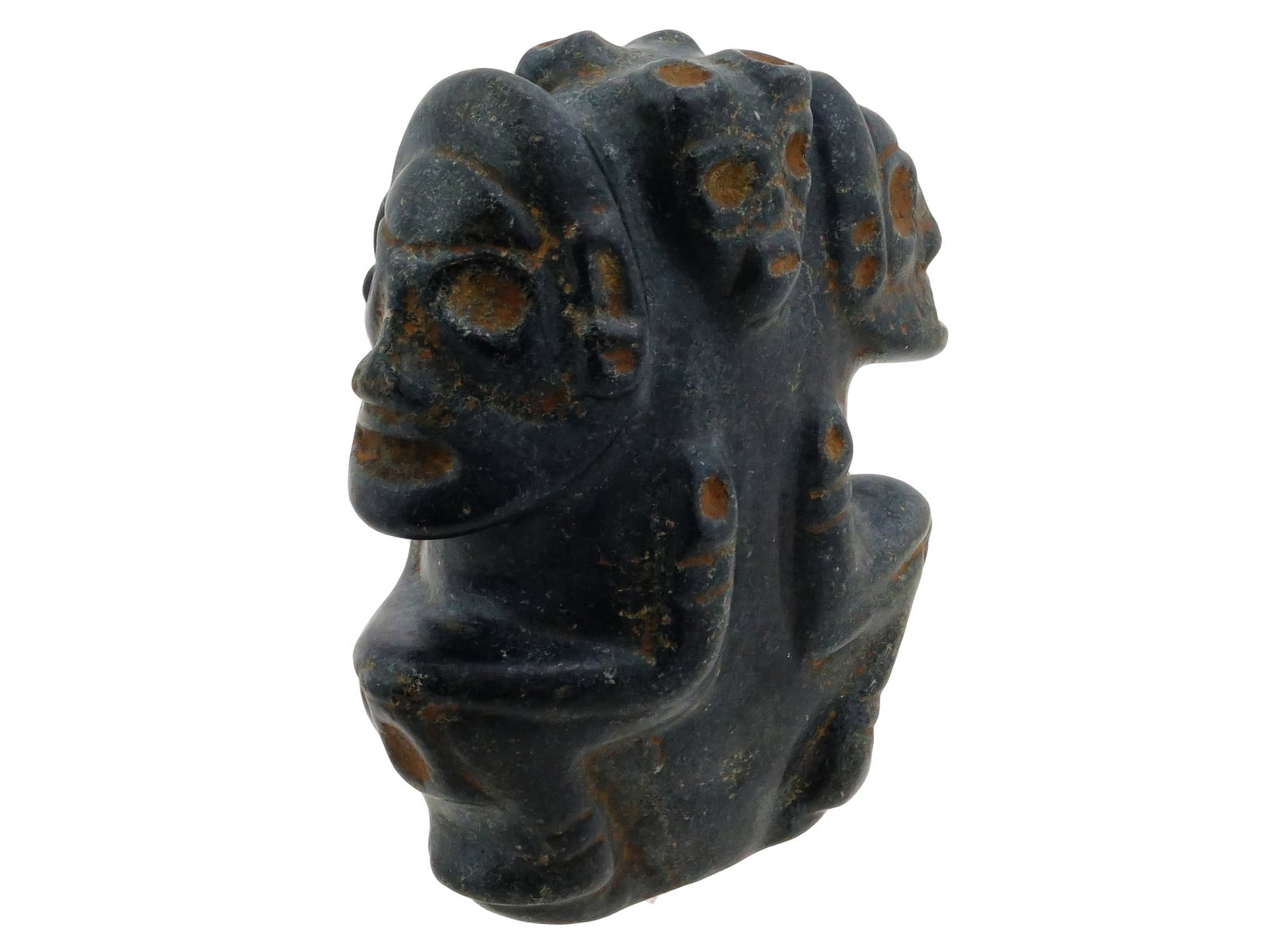 ANCIENT PRE COLUMBIAN THREE FACED CARVED STONE IDOL: An ancient Pre Columbian three faced or multi headed anthropomorphic stone idol. Features three distinct stylized heads or faces merged into a single body, a motif often signifying multi directional v