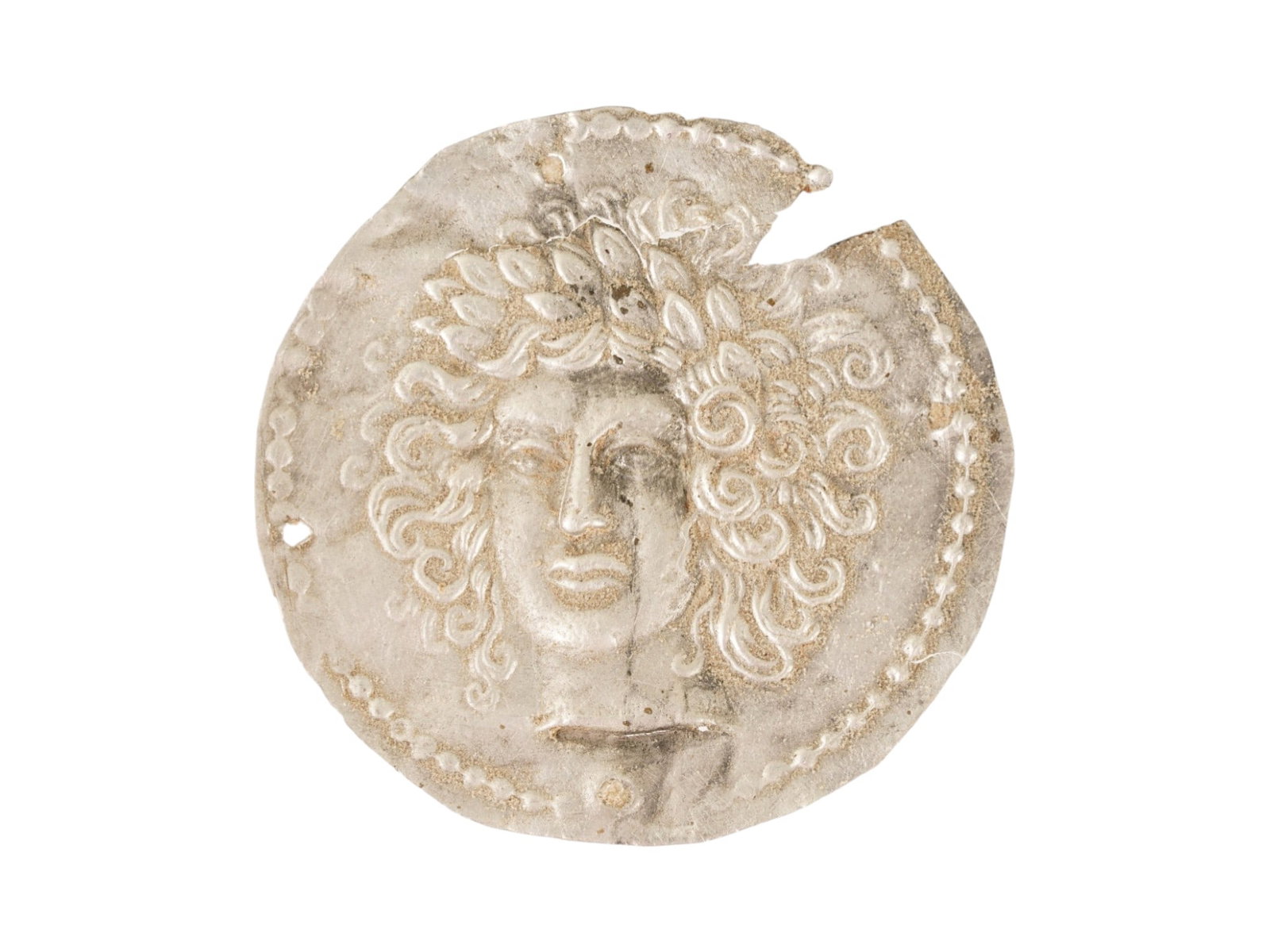 ANCIENT GRECO ROMAN SILVER PLAQUE WITH MEDUSA: An ancient Greco-Roman silver plaque depicting Medusa, dating circa 200 BC to 100 AD. Presents the iconic head of Medusa with stylized serpentine hair and intense frontal gaze, an image widely employe