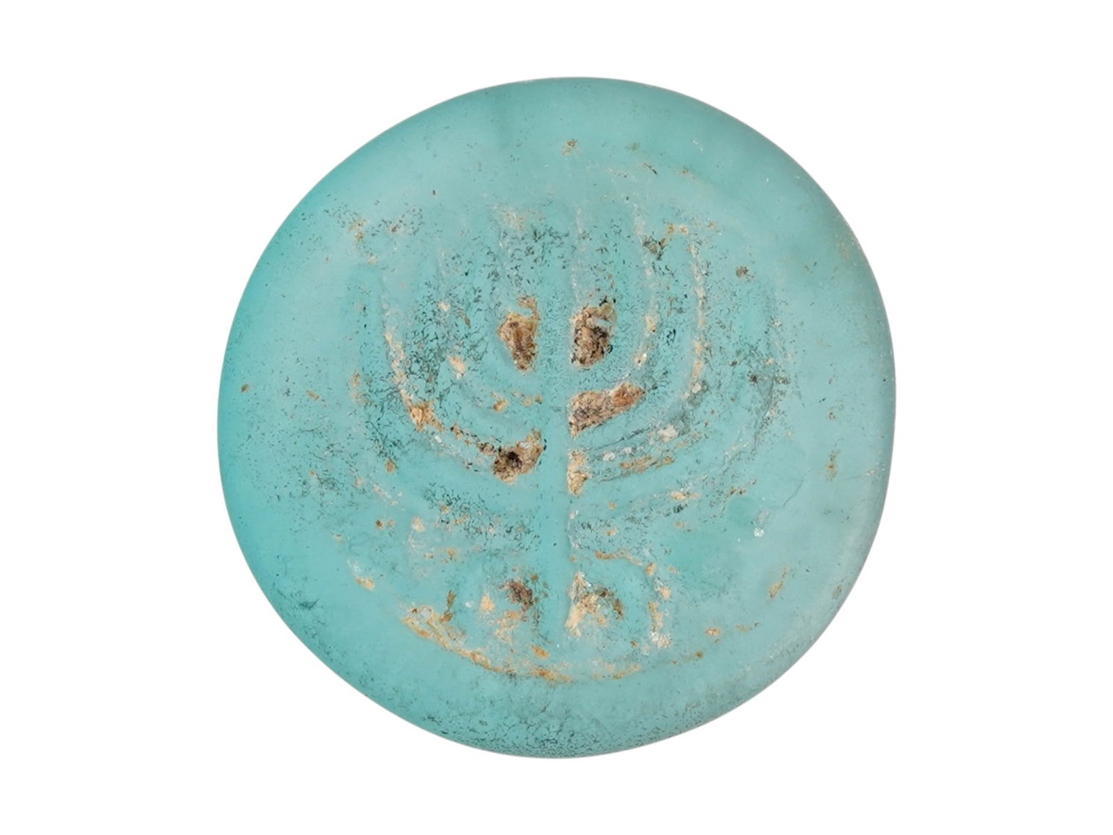 ANCIENT JUDAIC ROMAN GLASS MEDALLION W A MENORAH IMAGE: An ancient Judaic Roman glass medallion dating circa 100 to 300 AD, featuring a molded image of a menorah, a central symbol of Jewish identity and faith. The menorah motif underscores the presence of 