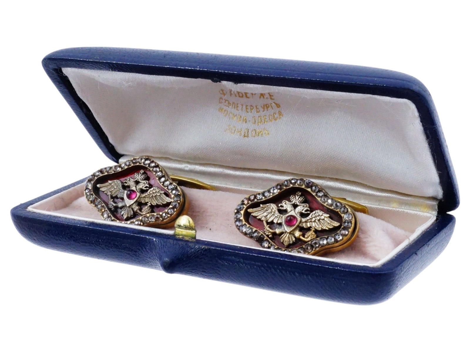 RUSSIAN EAGLE SILVER ENAMEL RUBY DIAMONDS CUFFLINKS: A pair of Russian 88 gilt Silver cufflinks. The diamond face of each cufflink is covered with a Guilloche enamel in a red shade, adorned with a relief image of an Imperial double headed eagle, encrust