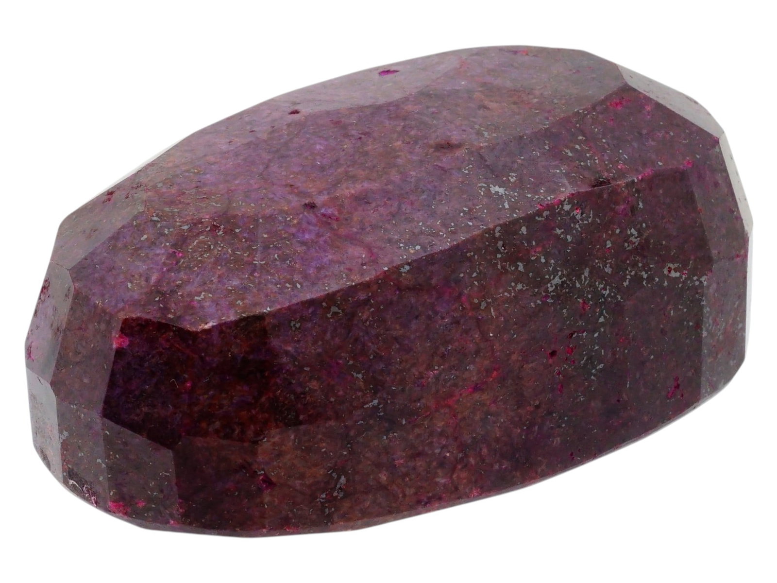 LARGE NATURAL UNTREATED BURGUNDY RUBY GEMSTONE: A large natural untreated ruby gemstone. The faceted oval stone has a dark burgundy hue with visible inclusions characteristic of natural minerals. Natural Stones And Minerals For Collectors. T