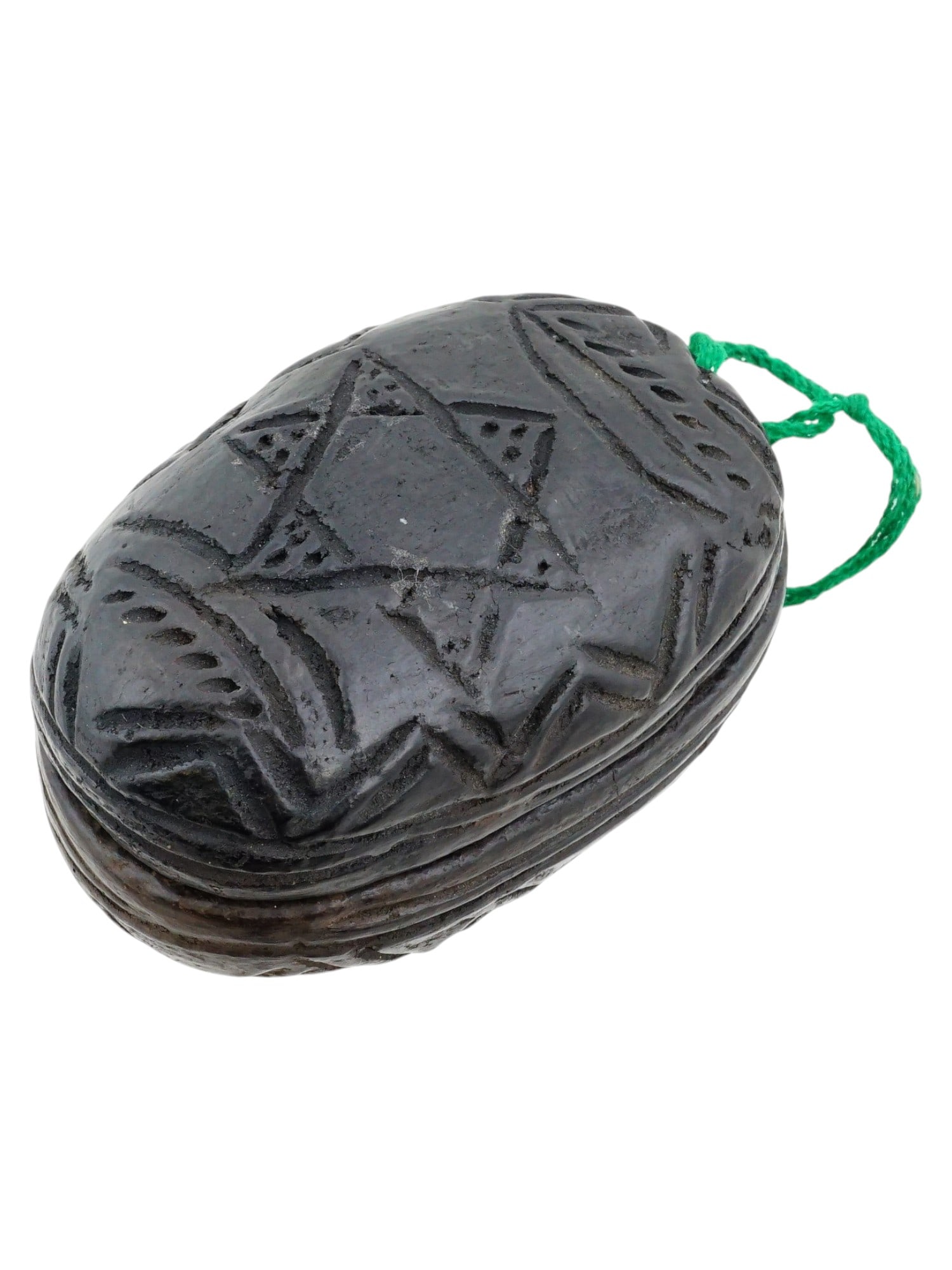 VINTAGE AFRICAN ETHIOPIAN JUDAICA AMULET: An African Ethiopian Judaica amulet. The miniature black amulet is divided into two halves. One half contains a figurine of a loving couple. The surface of the item is decorated with the Star of