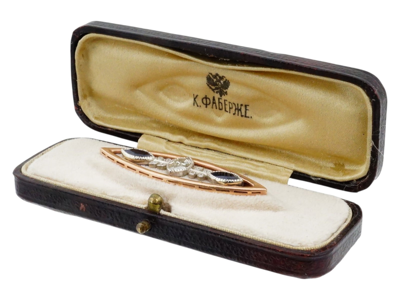 RUSSIAN 14K GOLD DIAMOND SAPPHIRE PIN BROOCH IN BOX: A Russian navette shaped 14K Gold brooch made in an openwork design, featuring a central marquise cut diamond flanked by two marquise cut blue sapphires. The gemstones are set within a yellow gold fra