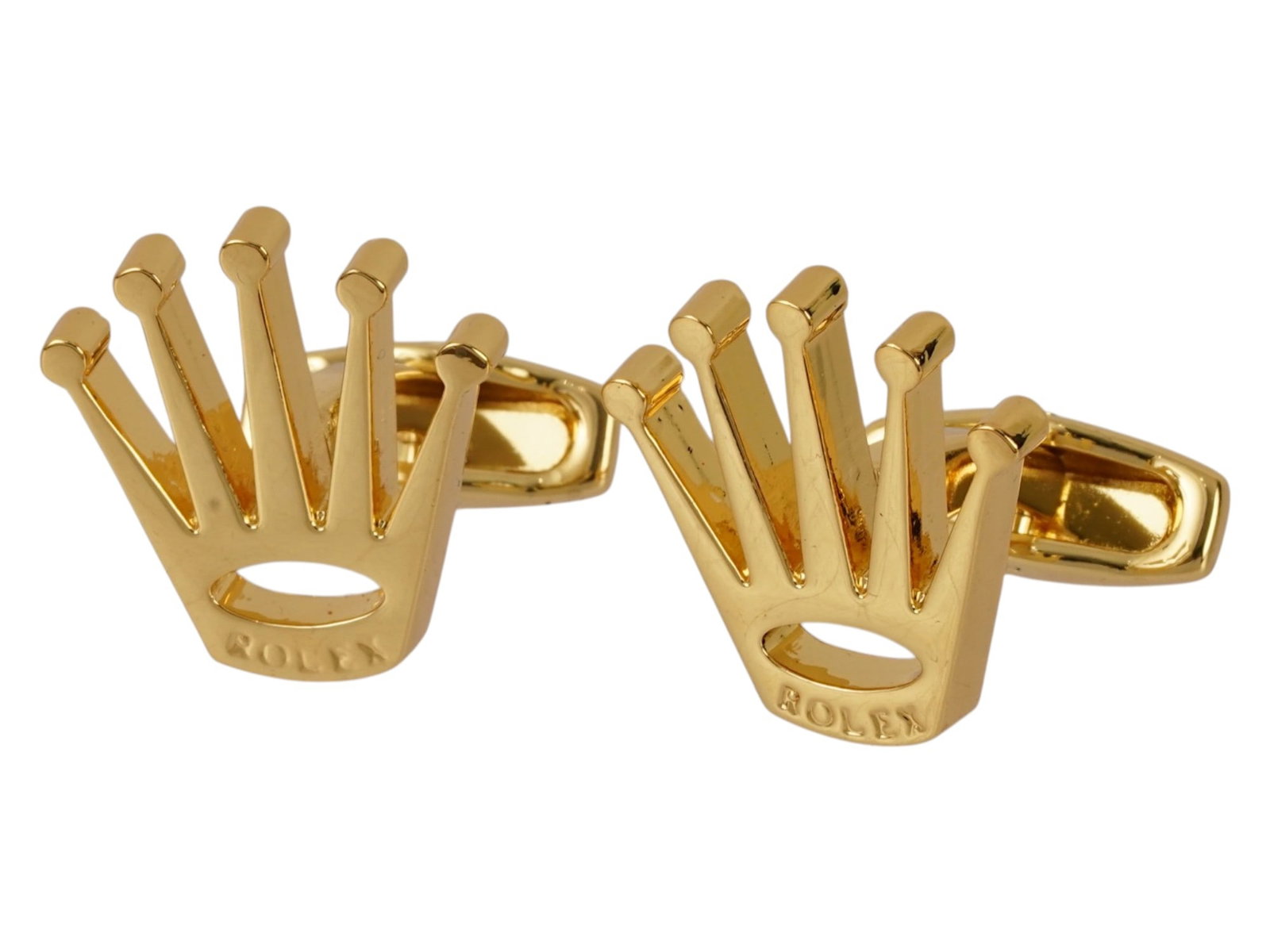 PAIR OF MENSWEAR ROLEX CROWN LOGO DESIGN CUFFLINKS: A pair of cufflinks is fashioned in the likeness of the signature five point Rolex crown logo, featuring a polished gold tone finish. Each piece is constructed with a swivel toggle back mechanism for