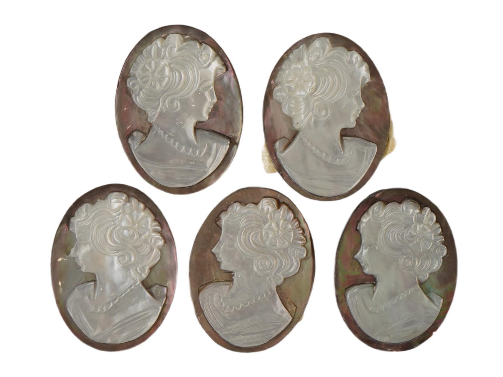 COLLECTION OF FEMALE PORTRAIT CARVED SHELL CAMEOS: A collection of hand carved conch chell cameos. A total of 5 items. Each piece is crafted from conch shell, featuring female profile portraits rendered in high relief. Oval shape. Collectible Jewelry 
