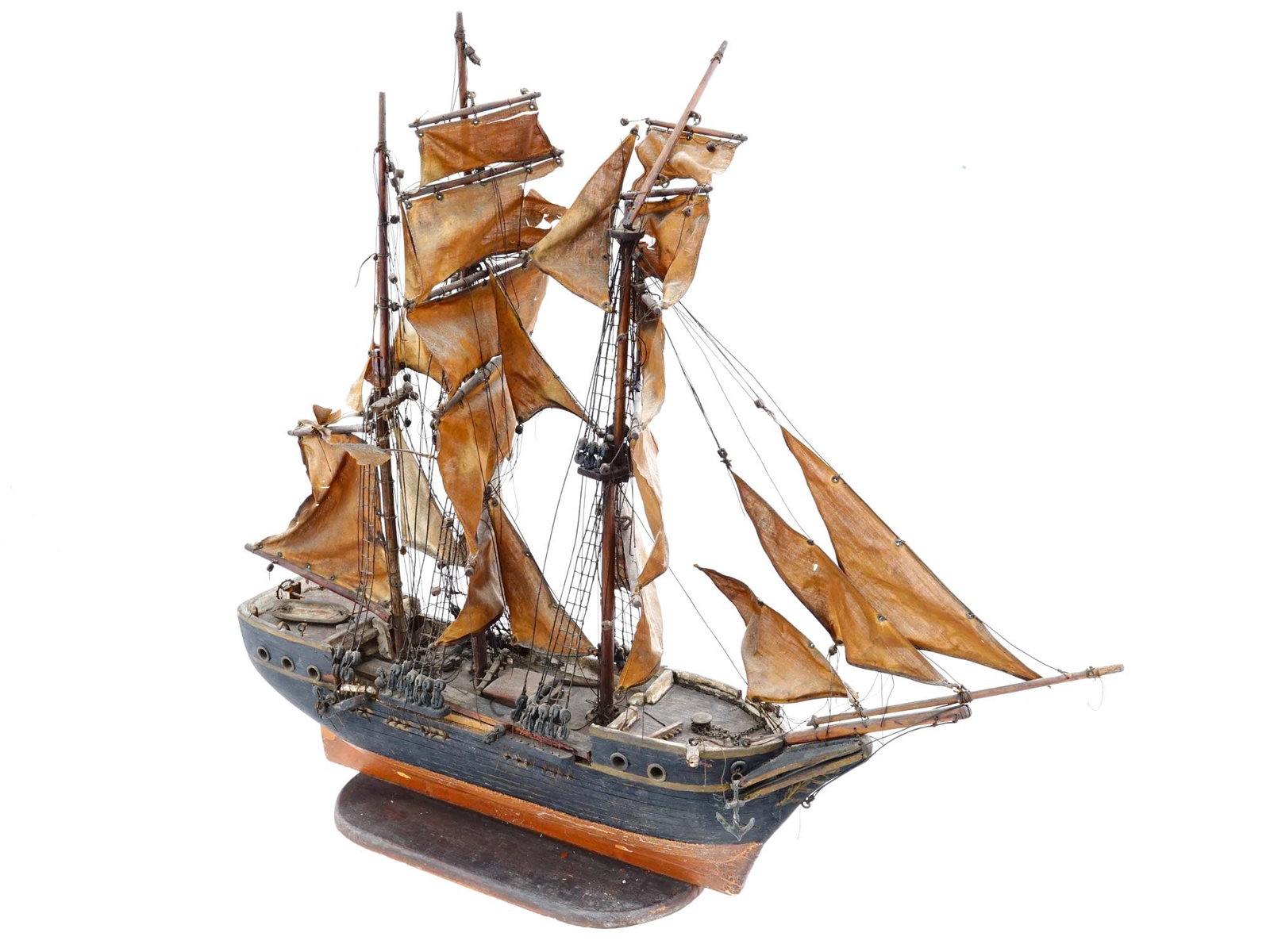 ANTIQUE DETAILED WOODEN MODEL BRIG SHIP: An antique hand painted model ship crafted from wood. A detailed model with an anchor and a boat and other details. The hull is painted in black with lighter colored wood accents along the waterline