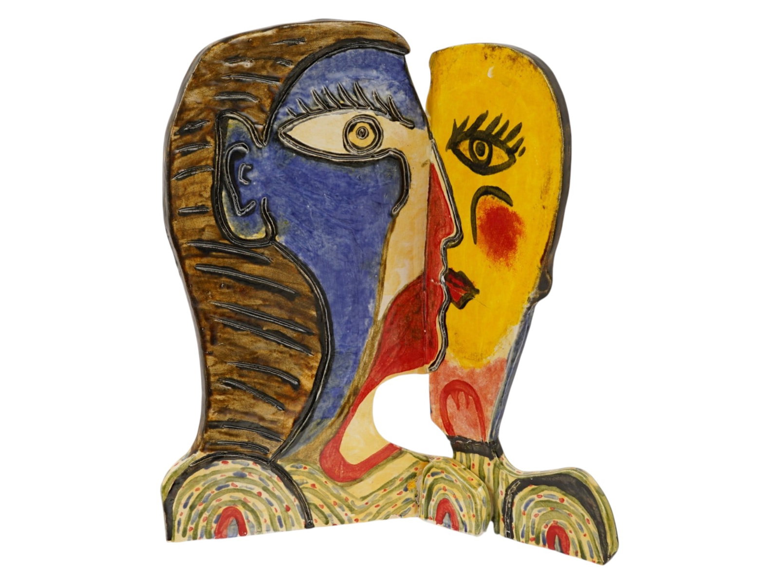 MODERNIST CERAMIC SCULPTURE AFTER PABLO PICASSO: A ceramic sculpture after the original painting by Pablo Picasso. The ceramic figurine features a stylized Cubist composition of a dual-profile face executed in a vibrant polychrome palette of yellow,