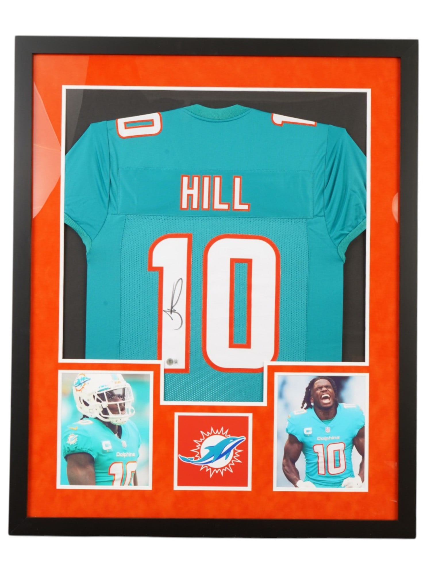 FRAMED TYREEK HILL SIGNED MIAMI DOLPHINS JERSEY BECKETT: This premier memorabilia centerpiece features a custom-framed Miami Dolphins jersey hand-signed by elite wide receiver and eight-time Pro Bowler Tyreek "Cheetah" Hill. Hill, one of the most explosive
