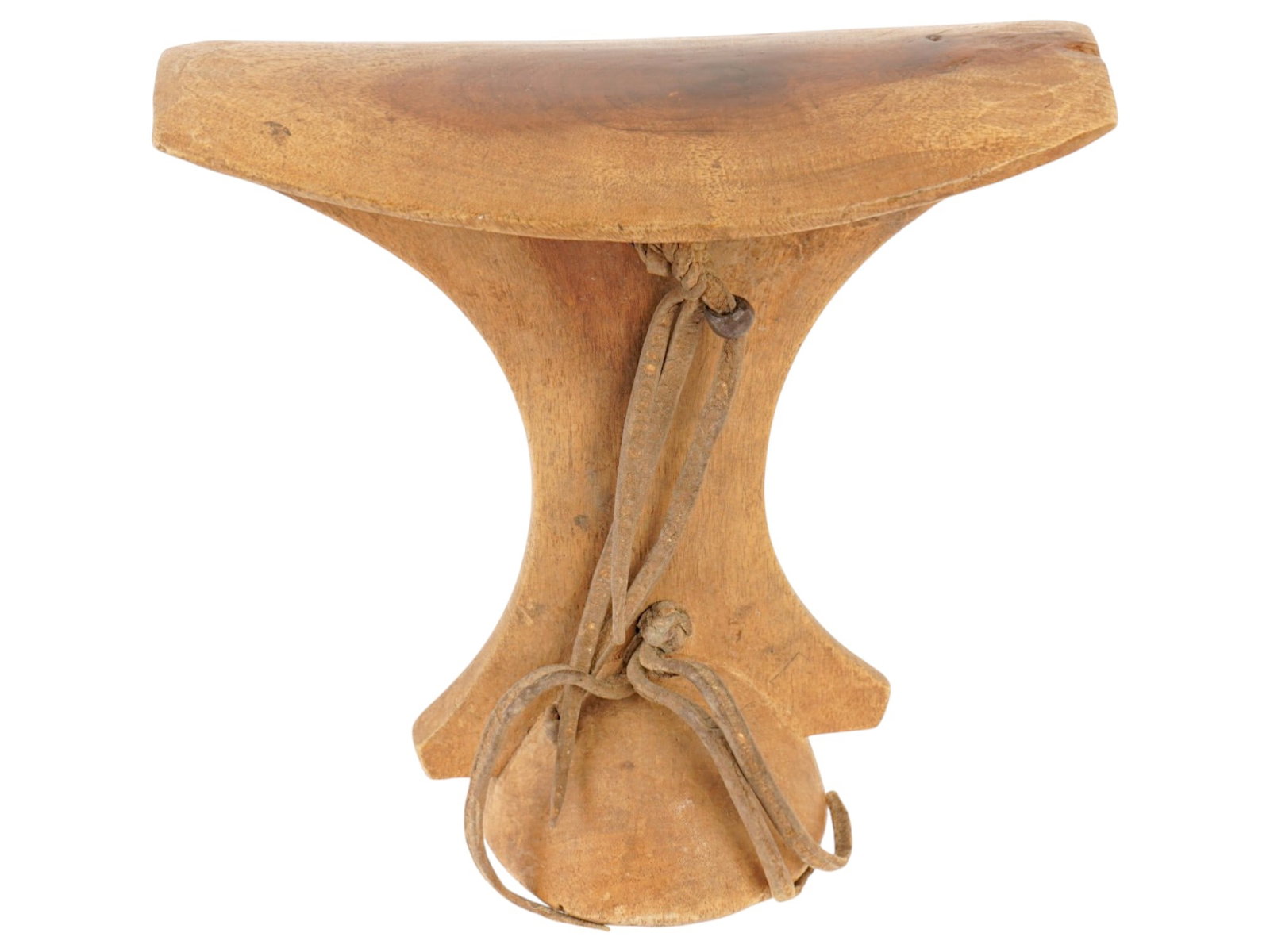 AFRICAN CARVED WOOD NECK OR HEAD REST W BRAIDED HANDLE: An African headrest is hand-carved from a single block of wood, featuring a smooth, concave top platform supported by a tapering central column and a flared, circular base. The edge of the top rest