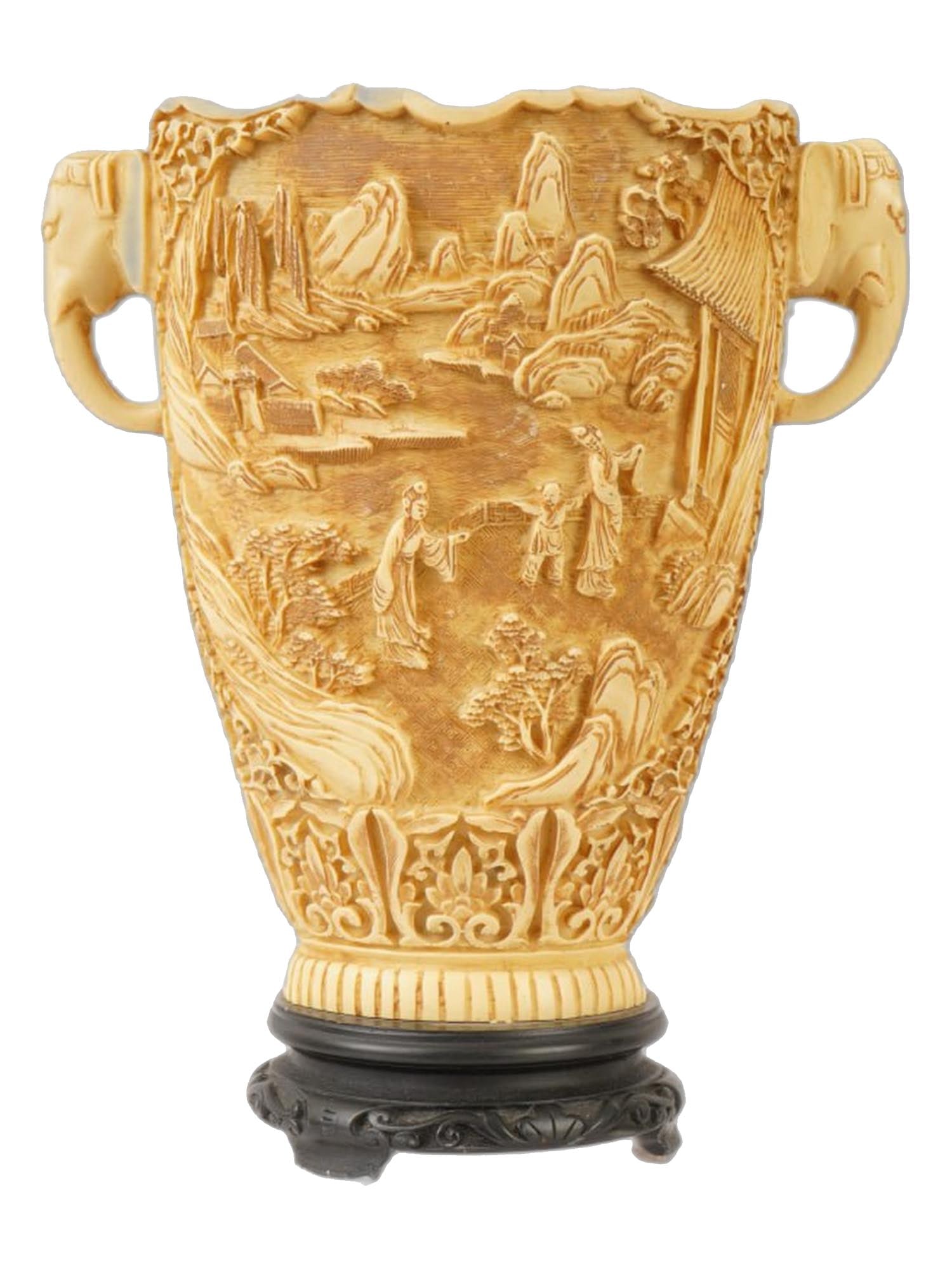 VINTAGE CHINESE CARVED COMPOSITE HANDLED VASE: A vintage Chinese carved composite handled vase. The entire surface of the wide vase is decorated with intricate relief genre scenes against a mountainous backdrop. The top edge is wavy. The handles a