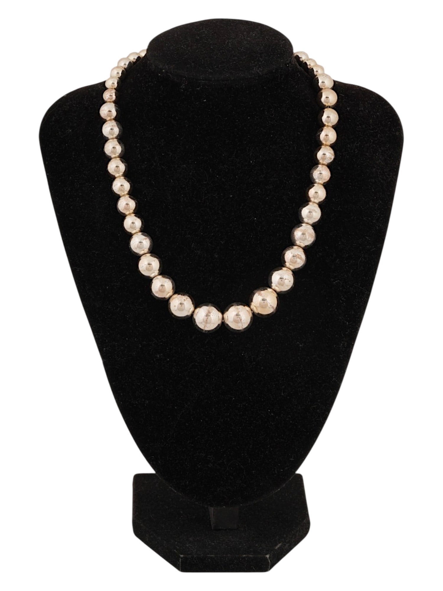 VINTAGE LAUREN RALPH LAUREN BEAD NECKLACE: A vintage Lauren Ralph Lauren necklace features a single strand of graduated beads with a metallic champagne finish. The beads transition in size from smaller elements near the clasp to larger spheres