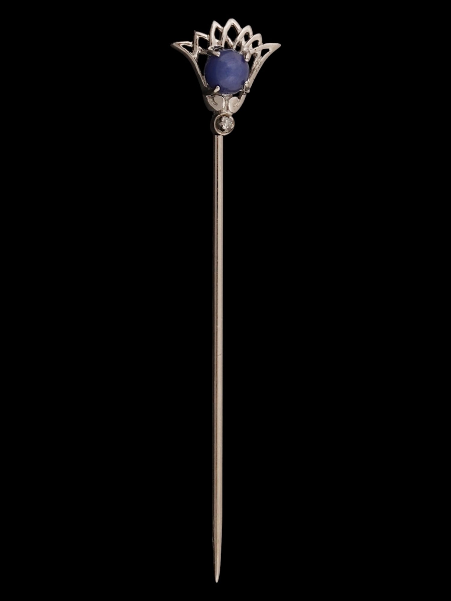 VINTAGE SAPPHIRE AND DIAMOND STERLING SILVER STICK PIN: A vintage sterling silver stick pin features an intricate Egyptian Revival lotus design accenting a central star sapphire cabochon and a single natural diamond drop. Marked on the back side. Vintage