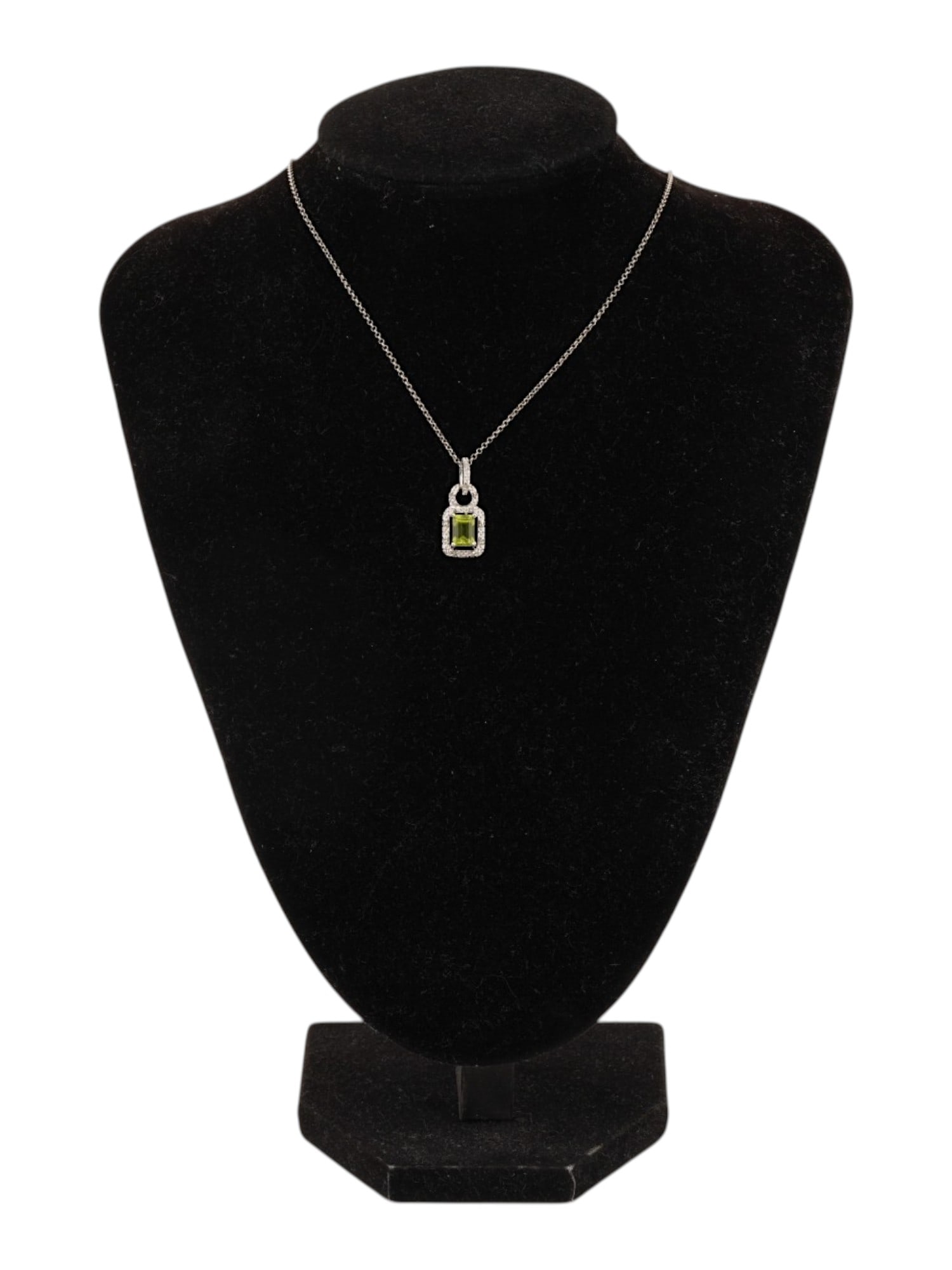 VINTAGE STERLING SILVER PERIDOTE DIAMONDS NECKLACE: A vintage sterling silver cable chain necklace with an octagon-cut peridote pendant encompassed with natural diamonds. Marked 925, Indonesia on the clasp. Total Weight: 3 g. Vintage Jewelry And Access