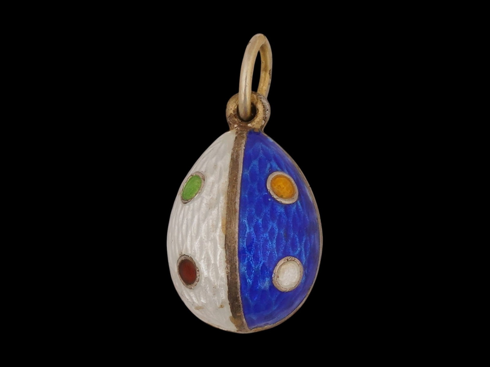 RUSSIAN SILVER GUILLOCHE ENAMEL EASTER EGG PENDANT: A Russian silver Easter egg pendant consisting of two parts, each divided in two and decorated with blue and white enamels manufactured in the guilloche technique. Each quarter of the egg features a