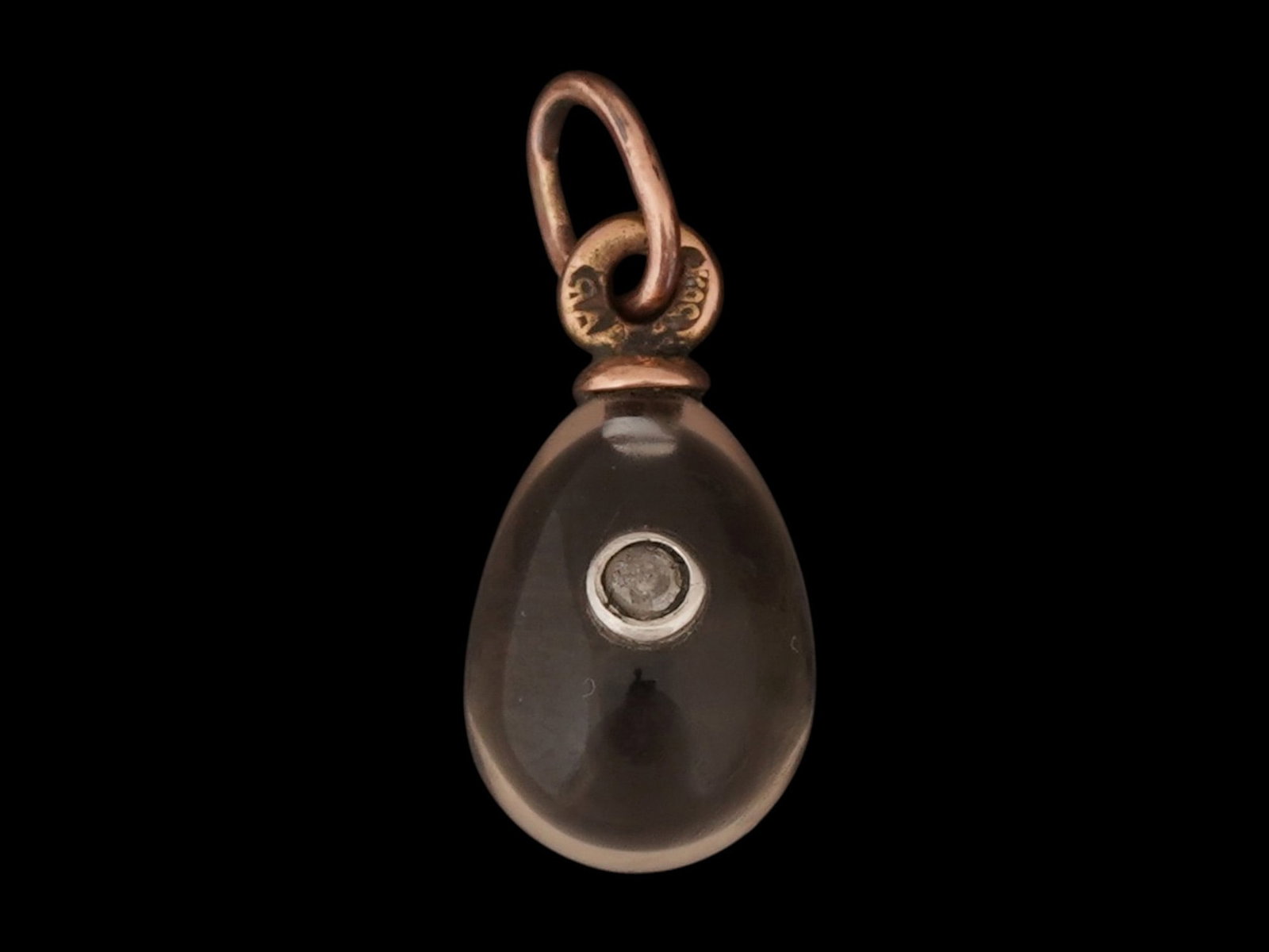 RUSSIAN 14K GOLD QUARTZ EASTER EGG PENDANT W DIAMOND: A Russian carved Smoky Quartz Easter egg pendant. The pendant is adorned with a central diamond and set in 14K gold fittings. Hallmarked to the suspension ring with 56 gold proof and makers marks.