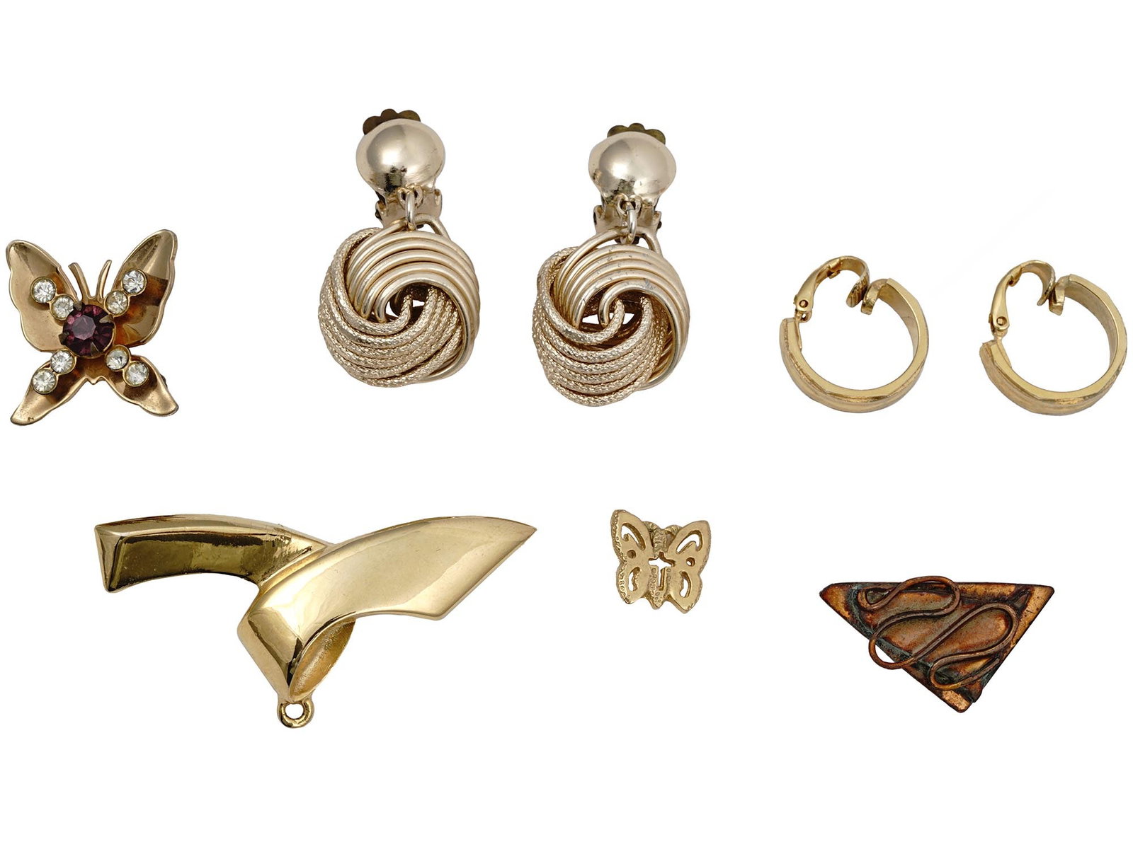 VINTAGE CUSTOM JEWELRY PINS AND CLIP EARRINGS: Vintage gold tone womens custom jewelry pieces. The lot includes two pairs of clip earrings, butterfly brooches, and more. One brooch has a screw lock. One pair of the earrings is made in West