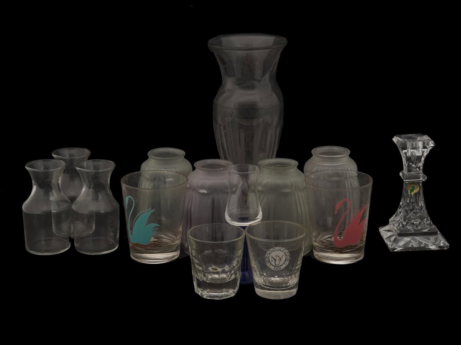 COLLECTION OF VINTAGE GLASS DRINK AND TABLE WARES: A collection of vintage glass drink and table wares. The collection includes a pair of glasses adorned with an enameled images of a swan; a small decanter, marked with a paper label, Waterford Crystal