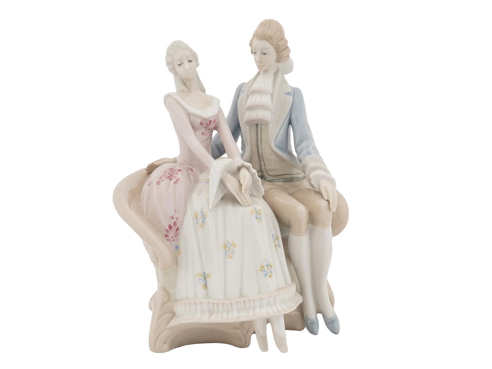 D'ART SA SPANISH PORCELAIN LOVE COUPLE FIGURINE: A hand-painted porcelain figurine by D'Art S.A., a Spanish porcelain manufacture. The figurine represents a young couple sitting on a couch, 18th-century Rococo style. Pastel blue and pink color palet