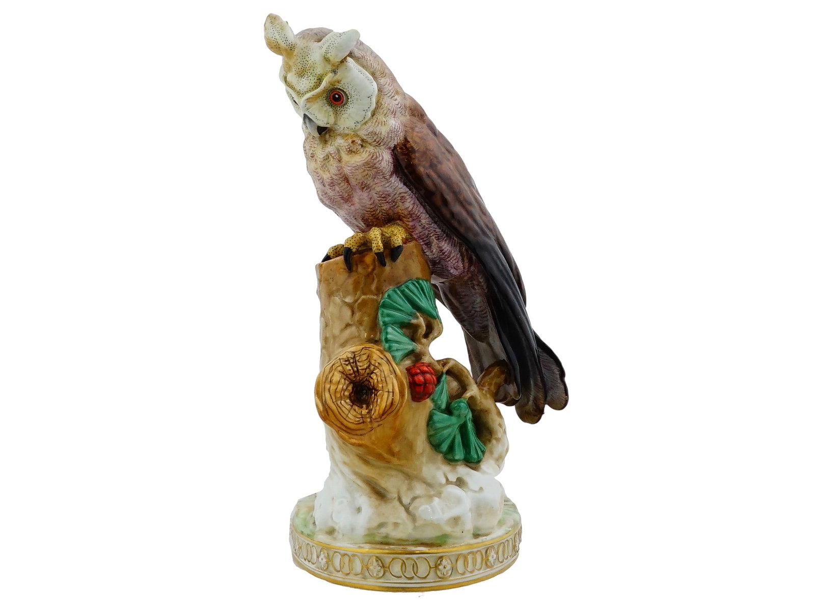 GERMAN DRESDEN PORCELAIN OWL FIGURINE: A German Dresden Porcelain porcelain figurine depicts a tufted owl perched atop a naturalistic tree stump base. The piece is hand-painted showcasing detailed plumage in earth tones of brown, ochre, an