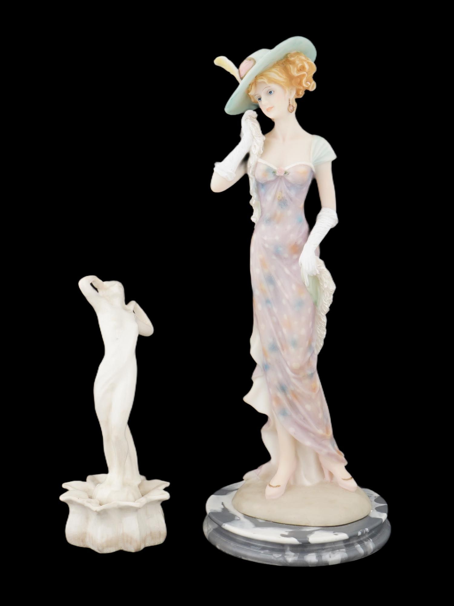 LOT OF ITALIAN COMPOSITE AND CERAMIC FEMALE FIGURES: A lot of two Italian Art Deco manner figurines. The lot includes an Italian composite sculpture depicting an elegant lady dressed in a hat, mounted on an oval base, marked with a paper label, Product 