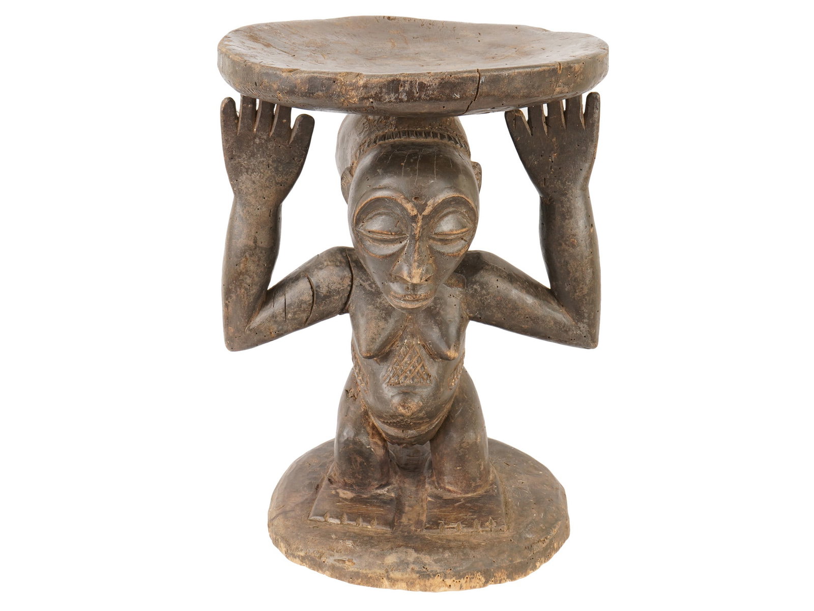 AFRICAN BAULE PEOPLE HAND CARVED WOODEN STOOL: An African hand-carved wooden stool from the Baule people of Ivory Coast features a central female caryatid figure in a kneeling position with arms raised to support a circular seat. The figure is det