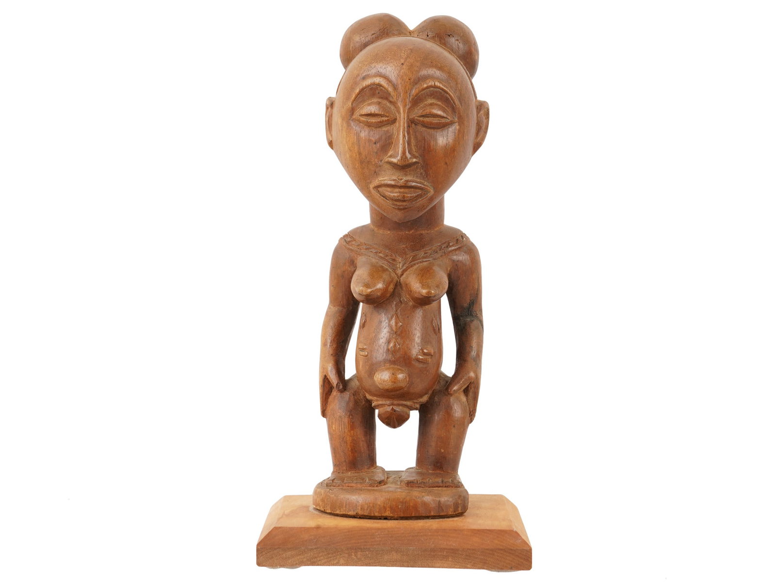 ANTIQUE AFRICAN CARVED WOODEN LUBA FERTILITY FIGURE: An African Luba fertility figure, carved in wood and distinguished by a large rounded head, almond-shaped eyes, and prominent facial features. Dating to the early 20th century. Provenance: Collection 