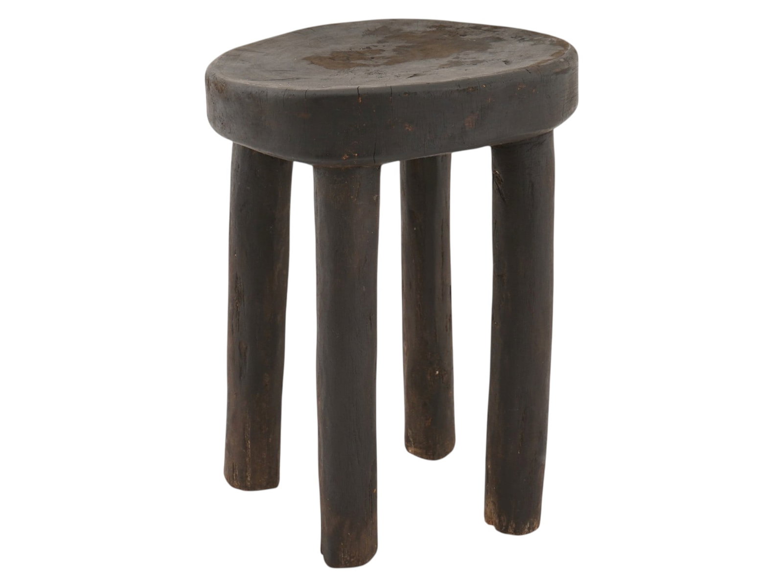 AFRICAN WOOD SENUFO MILKING STOOL FROM IVORY COAST: A West African stool, often called a Senufo milking stool from Ivory Coast. These stools are traditionally hand carved from a single piece of wood. They are distinguished by their sturdy, simple desig