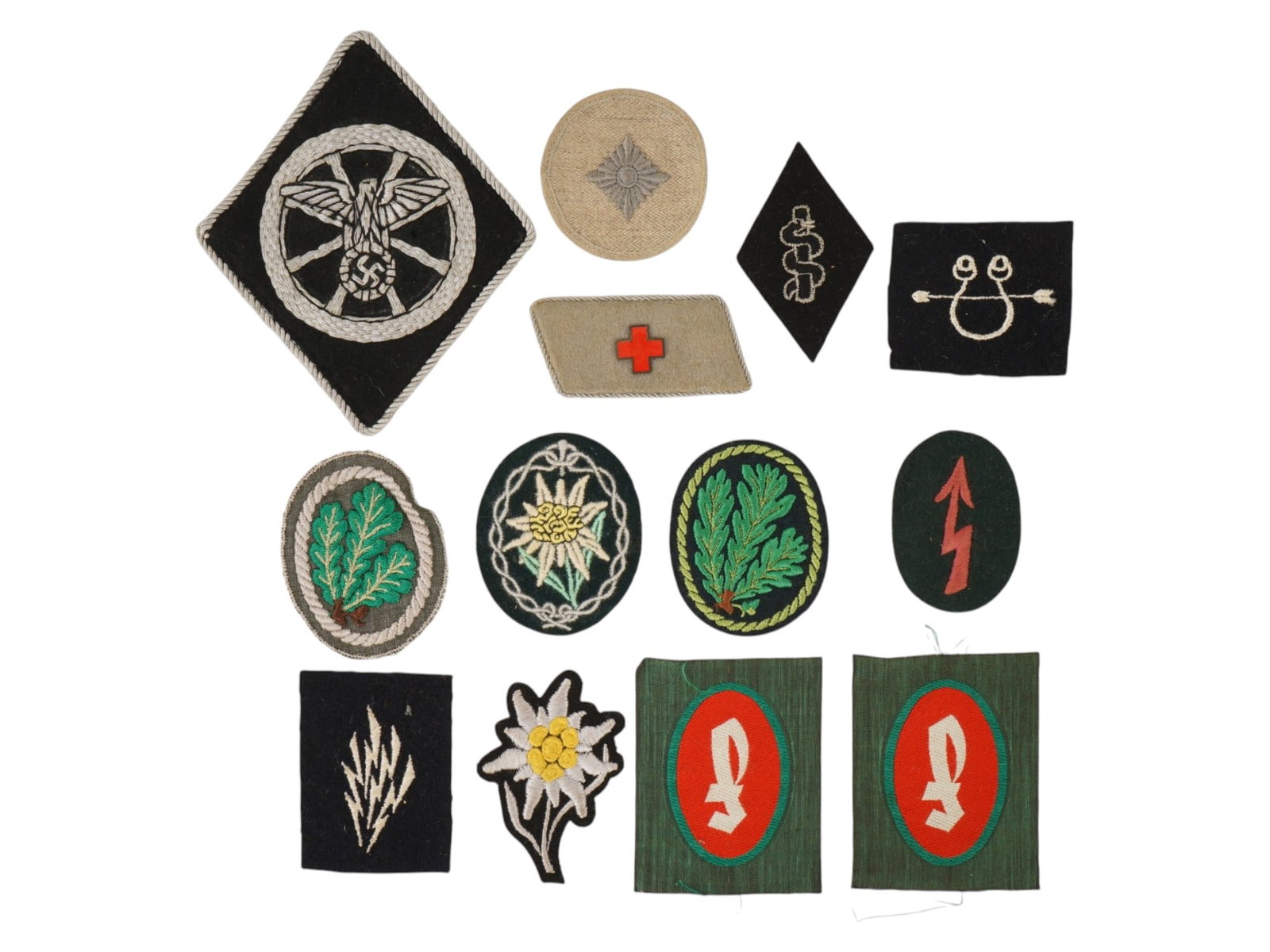 WWII TYPE GERMAN AND AMERICAN UNIFORM INSIGNIA: A collection of WWII type German and American insignia. The lot contains a German drivers diamond sleeve insignia of the National Socialist Mechanized Corps NSKK, a collar patch of the German Red Cros