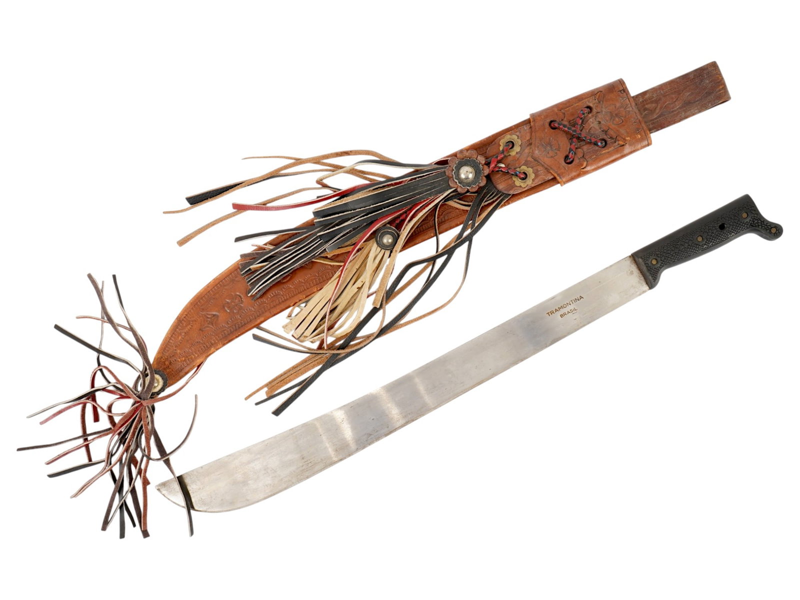 TRAMONTINA BRASIL MACHETE WITH LEATHER SHEATH: A vintage machete by Tramontina, Brasil. Stainless steel blade, hallmarked. Black resin handle. The piece comes in a brown leather sheath, decorated with tassels and figurative stamps, marked Panama. 