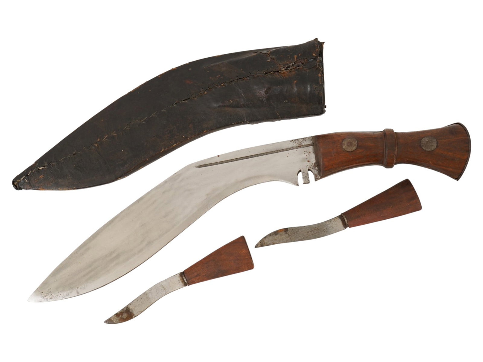 TRADITIONAL NEPALESE KUKRI WITH KARDA AND CHAKMAK: A Nepalese kukri features a traditional recurved steel blade with a characteristic notch near the bolster. The hilt is carved from polished wood, featuring a central raised ridge and a flared pommel.