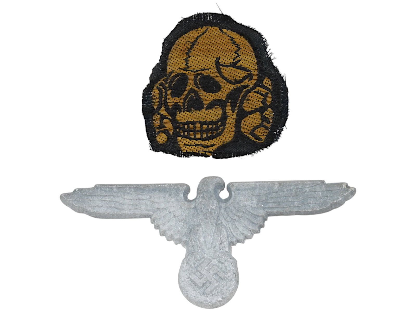 WWII NAZI GERMAN WAFFEN SS VISOR CAP PIN SS SKULLPATCH: A lot of two World War II Nazi German items including a Waffen SS visor cap pin with swastika. Marked RZM and numbered on the backside. The second item features an SS skull patch. Second World War His