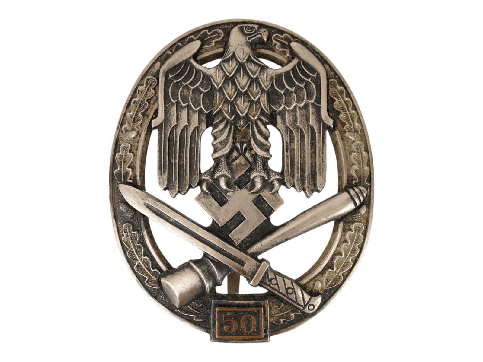 WWII NAZI GERMAN 50 DAYS GENERAL ASSAULT BADGE: A WWII Nazi German badge For participation in general assault attacks 3rd degree for 50 days of fighting. The badge is oval in shape and framed by an oak wreath. There is a massive Nazi eagle with fol