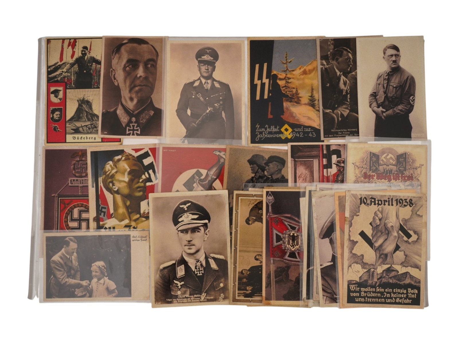 COLLECTION OF WWII ERA GERMAN POSTCARDS: A lot of German postcards. A total of 28 items, dated 1930s to 1940s. Thematic range: Nazi insignia, patriotic art, portraits of military officials. Second World War Historical Relics, German Post, Ph