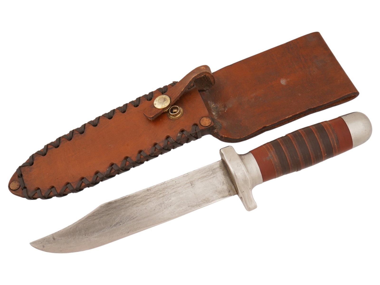 BOWIE HUNTING KNIFE WTH LEATHER SHEATH: A vintage Bowie hunting knife features a classic clip-point steel blade. The hilt is constructed with a stacked leather washer handle, terminated by a rounded metal pommel and protected by a double-si