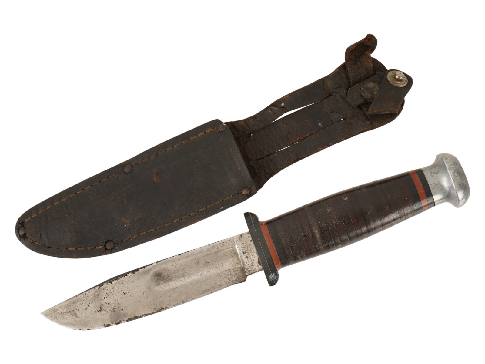 VINTAGE AMERICAN MILITARY COMBAT KNIFE BY KINFOLKS: A vintage American military combat knife by Kinfolks. The knife features a clip-point blade and a stacked leather handle. Marked on the ricasso. Comes with a brown leather scabbard. Such knives were a