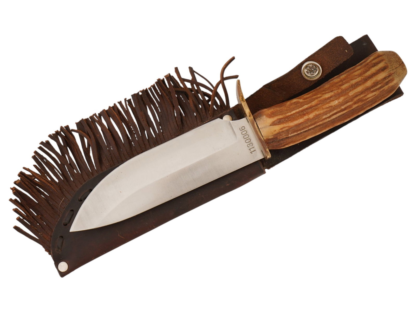 SCHRADE UNCLE HENRY LIMITED EDITION HUNTING KNIFE: An American Schrade Uncle Henry Limited Edition fixed blade hunting knife with its leather sheath. It features a wide, stainless steel blade with a drop-point bowie style profile. The ricasso is