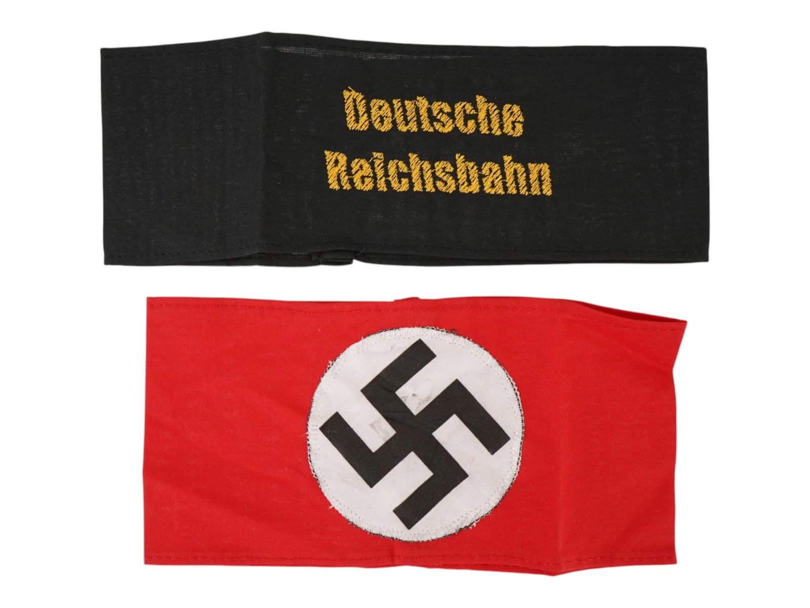 TWO GERMAN WWII TYPE ARMBANDS NSDAP GERMAN REICHSBAHN: A lot of two WWII type Nazi German armbands. The first is a National Socialist German Workers Party armband featuring a black swastika on a white circular field, applied to a red cotton ground. The se