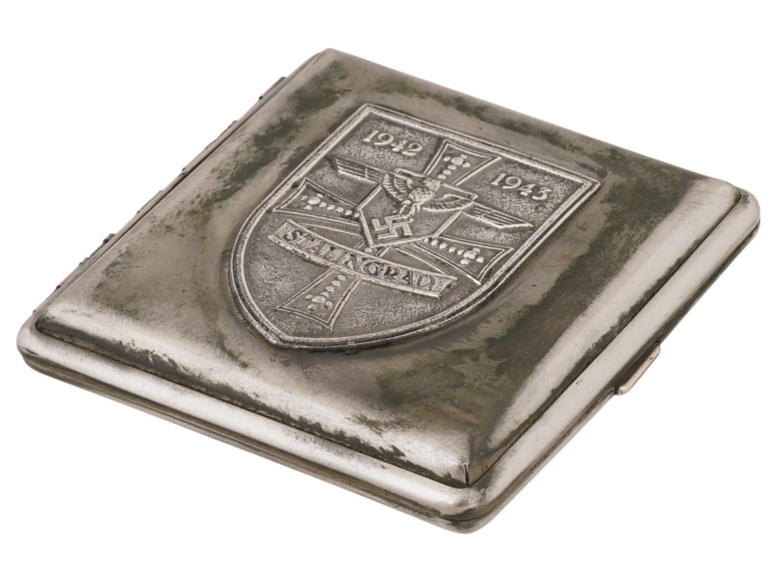 WWII TYPE GERMAN BATTLE FOR STALINGRAD CIGARETTE CASE: A World War II type German stainless steel cigarette case. The front cover is decorated with an embossed coat of arms which presents th German cross, Reichsadler with swastika, inscriptions 1942-1943,