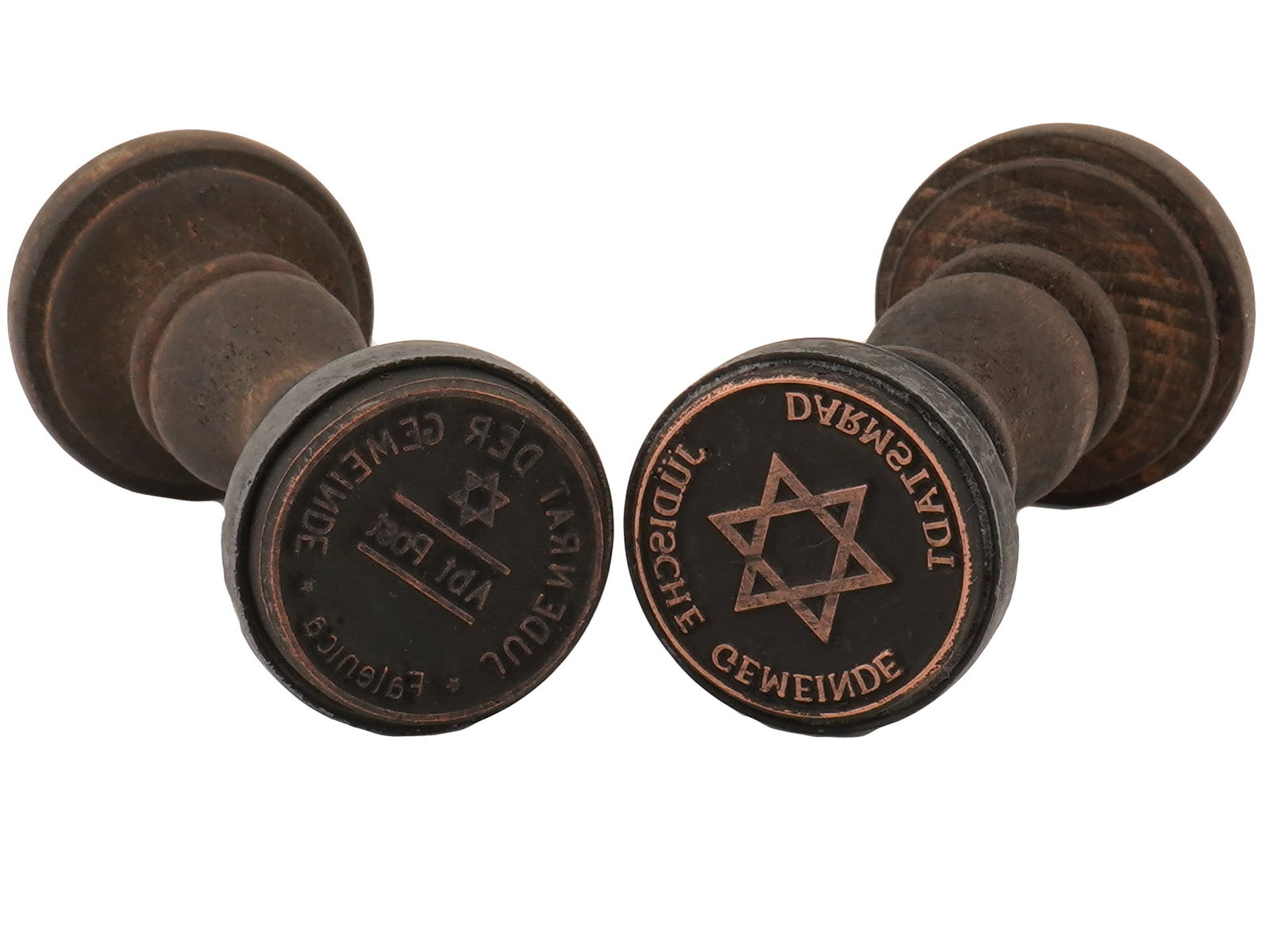 GROUP OF WWII MODEL NAZI GERMAN HOLOCAUST HAND STAMPS: A group of two WWII model Nazi German Holocaust period wood and metal ink hand stamps including Darmstadt Ghetto and Judenrat der Gemeinde unknown Ghetto stamps. Each is adorned with a design represen