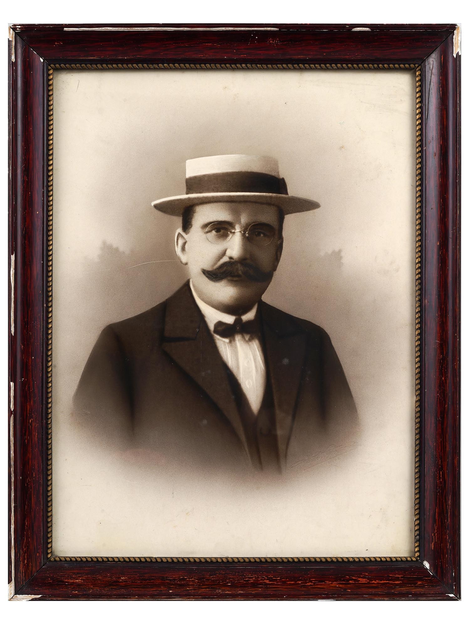 ANTIQUE AMERICAN MALE PORTRAIT CABINET PHOTOGRAPH: An antique early 20th-century American cabinet photo portrait of a man in hat and glasses. Embossed studio stamp in the lower right. Wooden frame. Collectible Antique Photographs, Historical Relics, V