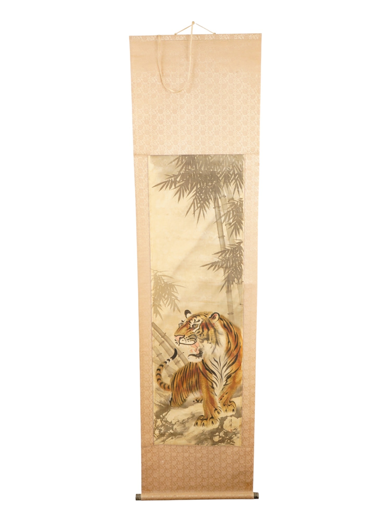 CHINESE HANGING SCROLL PAINTING OF A TIGER ON SILK: A vintage Chinese hanging scroll painting. Ink and watercolor on silk. Vertical format. The artwork depicts a tiger in bamboo forest. Unsigned. One-color mounting style. Wooden bars with suspension. C
