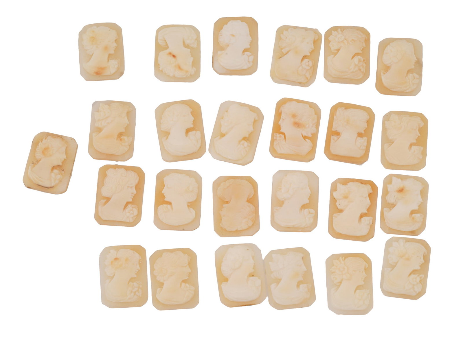 COLLECTION OF FEMALE PORTRAIT CARVED SHELL CAMEOS: A collection of hand carved shell cameos. A total of 25 items. Each piece depicts a female profile portrait rendered in high relief in the Victorian manner. Each cameo is fashioned in a distinctive oc