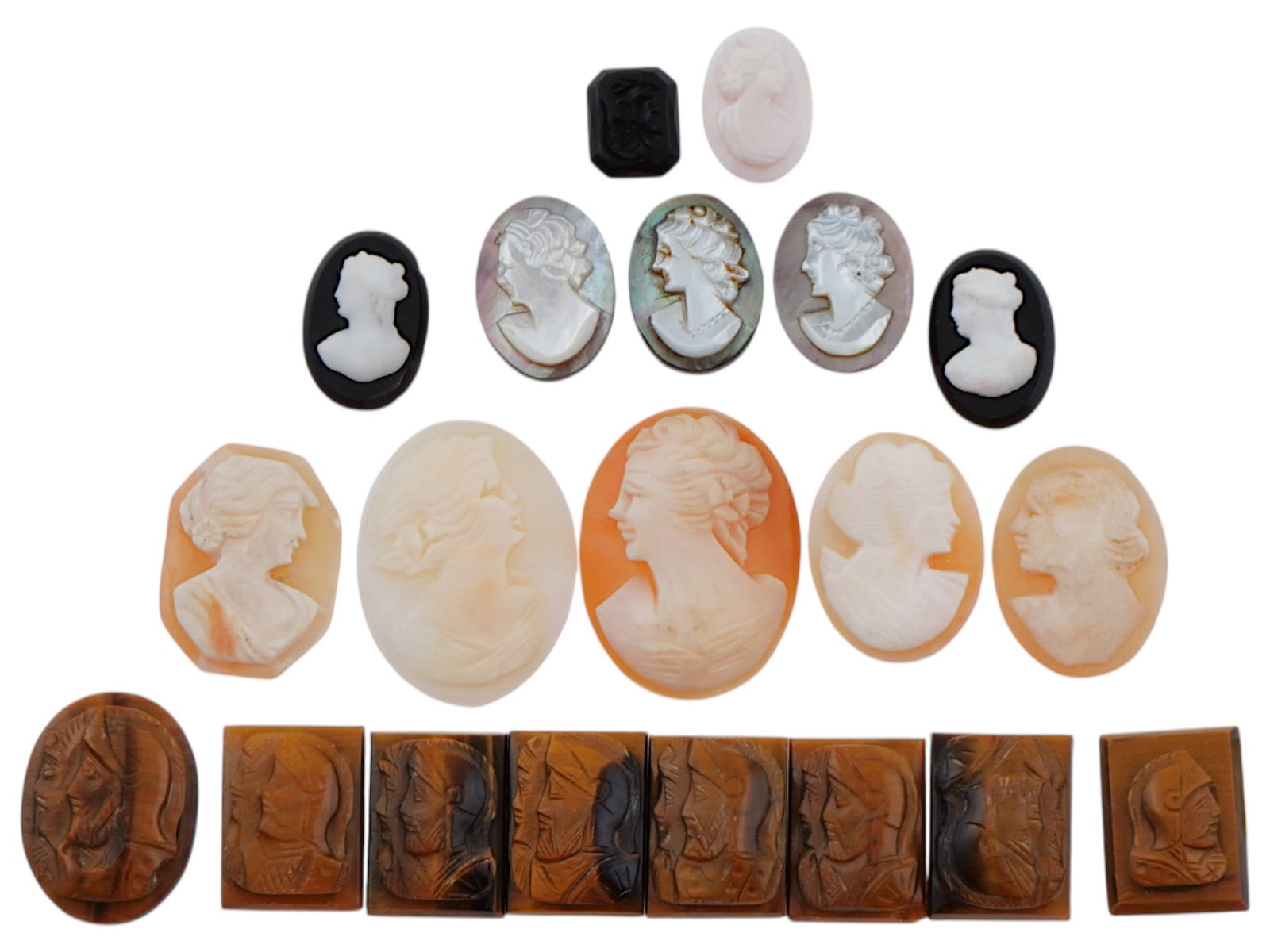 COLLECTION OF ANTIQUE HAND CARVED CAMEOS: A large collection of antique Neoclassical hand carved cameos. Some pieces feature double portraits of warriors, and some feature female portraits. Oval and rectangular shaped. Dating back to the late
